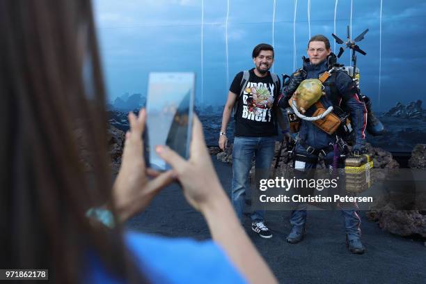 Game enthusiasts and industry personnel pose for a photograph at a 'Death Stranding' booth during the Sony Playstation E3 conference at LA Center...