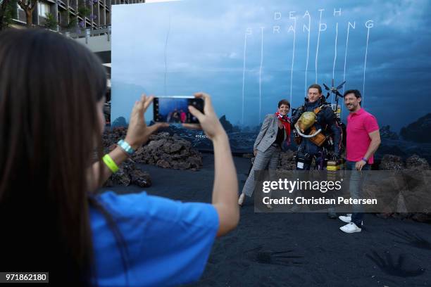 Game enthusiasts and industry personnel pose for a photograph at a 'Death Stranding' booth during the Sony Playstation E3 conference at LA Center...