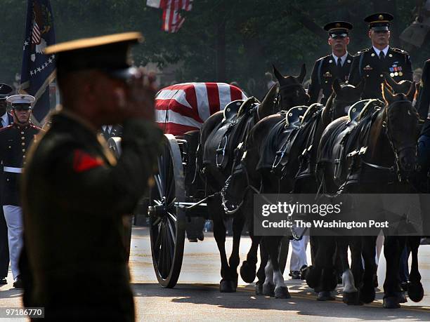 Military man salutes on Constitution Ave. As the funeral procession for Former President Ronald Reagan approached the U.S. Capitol.