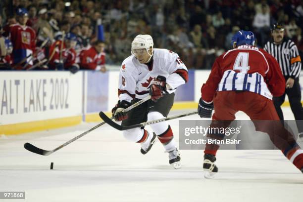 Jarome Iginla of Canada races past Roman Hamrlik of the Czech Republic with the puck during the Salt Lake City Winter Olympic Games at the E Center...