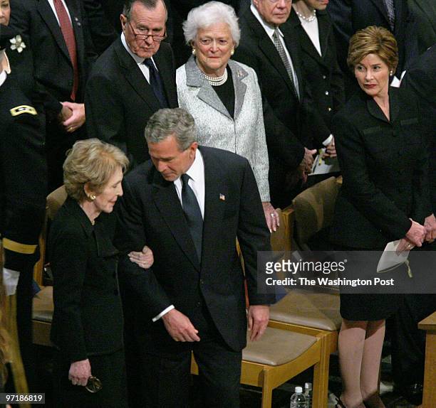 The official funeral service for the late Ronald Reagan at Washington National Cathedral. Pictured, President George Bush steps out to welcome Nancy...