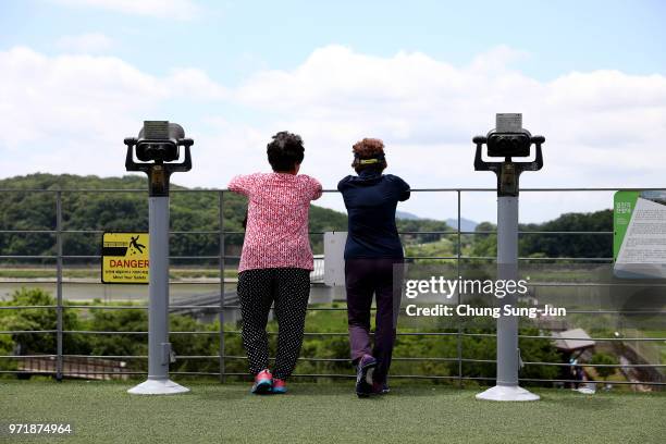 South Koreans look over the North Korea at the Imjingak observation post, near the demilitarized zone on June 12, 2018 in Paju, South Korea. U.S....