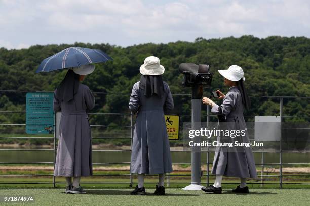 South Korean nuns look over the North Korea at the Imjingak observation post, near the demilitarized zone on June 12, 2018 in Paju, South Korea. U.S....