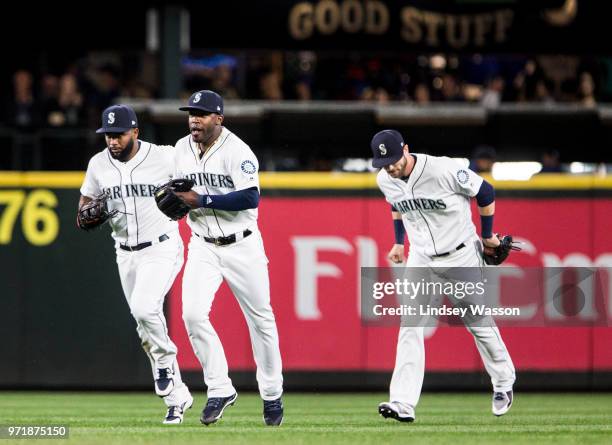 Denard Span of the Seattle Mariners, Guillermo Heredia and Mitch Haniger run towards the infield after beating the Los Angeles Angels of Anaheim at...