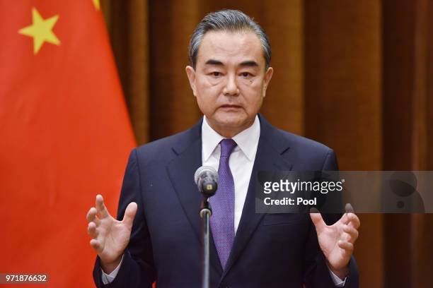Chinese Foreign Minister Wang Yi speaks about the summit between US President Donald Trump and North Korean leader Kim Jong Un, during a joint...
