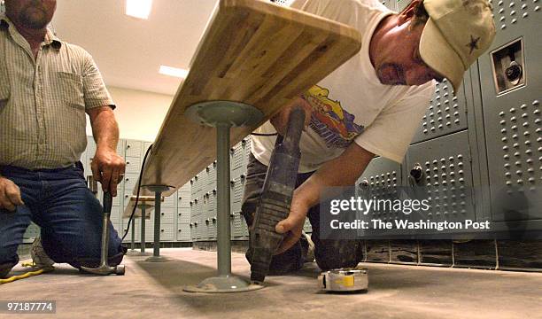 Sm_school 08-19-04 Huntingtown, Md Mark Gail/TWP left to right-Jack Hass watchs as George Hall drills a hole to hold a bench in the boy's locker room...