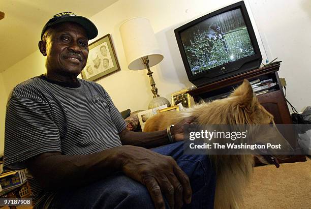 Me-dogs 8/27/04 Clinton, Md. #159000 Mark Gail_TWP Retired Navy petty officer Rudolph Thomas sits in his Clinton home with his collie, "Brownie" who...