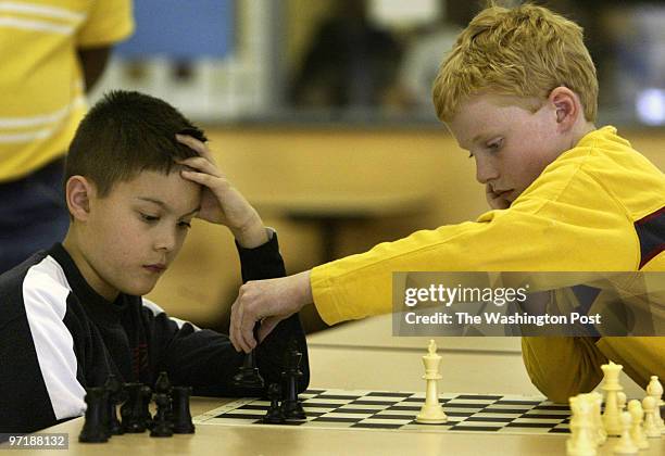Sm-chess 2-28-04 Waldorf, Md Mark Gail_TWP J.C. Parks Elementary school's Alex Gonzales watchs as Grace Lutheran's Daniel Scanlan makes a move in...