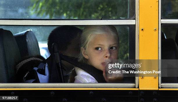 Sm_firstday 08-24-04 Sunderland, Md Mark Gail/TWP Sunderland elementary school fourth grader Kelly Jensen waits her turn to get off the bus before...