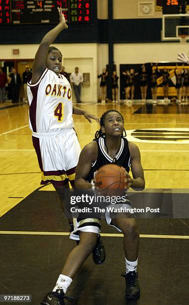 02/20/04 PHOTO BY : JOEL RICHARDSON 152406 WESTFIELD BEATS OAKTON ,,, WESTFIELD'S 21 TIFFANY TORRES STOPS AS OAKTON'S 4 BASSEY NYAMBI COMES OVER THE...