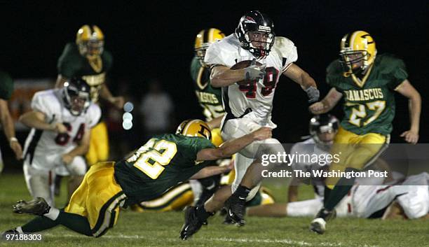 Neg#:159438 Photog:Preston Keres/TWP Damascus HS, Damascus, Md. Linganore's Matt Castor breaks through Travis Wertz and the Damascus defense for a 80...