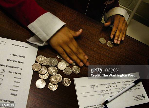 Photog: Gerald Martineau Jefferson-Houston Elem. School Alex, VA neg: 152139 kids run credit union The day's deposits are counted at the end of the...