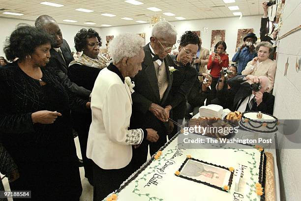Sm-party 01-31-04 Mark Gail_TWP Caption-William Butler with his wife Hazel of 74 years and niece Grace Newman cut the cake surround by family members...