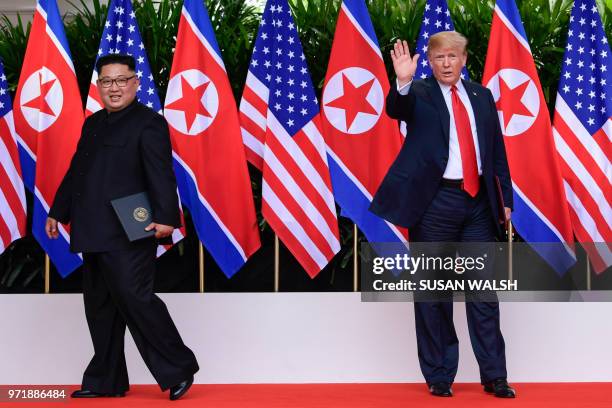 President Donald Turmp waves as North Korea leader Kim Jong Un leaves after their meetings at the Capella resort on Sentosa Island in Singapore on...