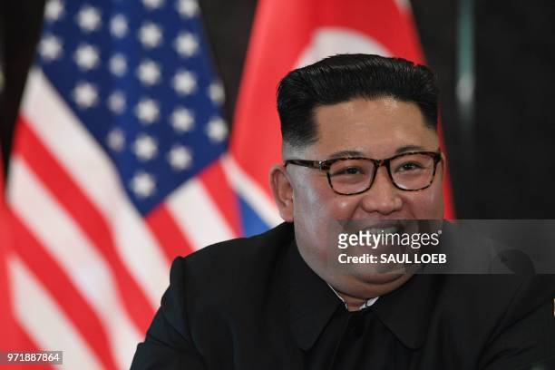 North Korea's leader Kim Jong Un reacts at a signing ceremony with US President Donald Trump during their historic US-North Korea summit, at the...