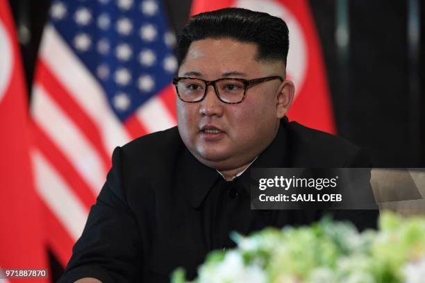 North Korea's leader Kim Jong Un speaks at a signing ceremony with US President Donald Trump during their historic US-North Korea summit, at the...