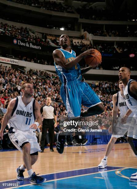 Darren Collison of the New Orleans Hornets goes up for the layup against Jose Juan Barea and Caron Butler of the Dallas Mavericks during a game at...