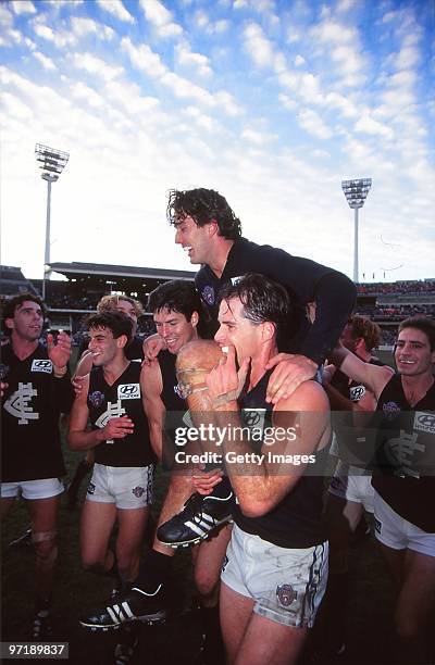 Stephen Silvagni of the Blues is chaired off the ground by team mates after playing in his 200th AFL match during the round 12 AFL match between...