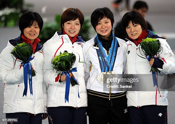 Maki Tabata, Nao Kodaira, Miho Takagi and Masako Hozumi of Japan Ladies Pursuit Team pose for photographs after the medal ceremony of the ladies'...