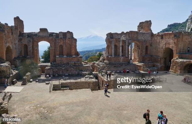 Teatro Greco, the ancient greek theatre is facing Mount Etna on April 8, 2018 in Taormina, Sicily, Italy.