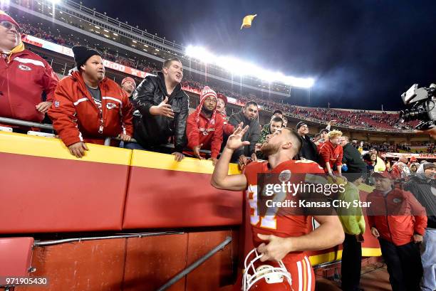 Kansas City Chiefs tight end Travis Kelce tosses a glove into the stands after a 30-13 win against the Los Angeles Chargers on Saturday, Dec. 16 at...