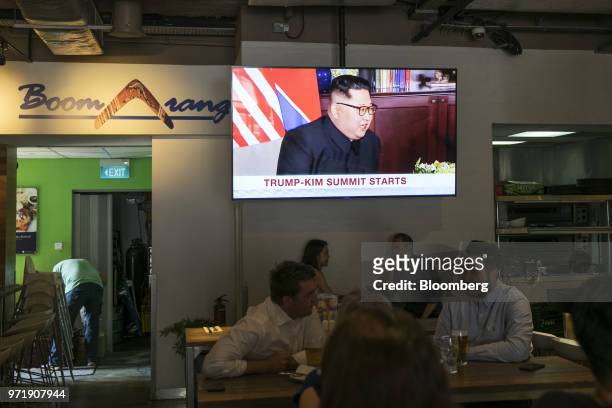 Screen displays a news broadcast of North Korean leader Kim Jong Un attending the DPRK-USA Singapore Summit, at a restaurant in Singapore, on...