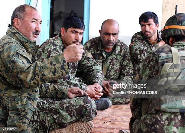 Showal, l'Otan a installé son QG chez un producteur de pavot" by Hervé Asquin In this February 28, 2010 photograph, Afghan army Colonel Abdul Hussein...