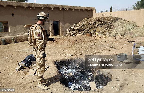 Showal, l'Otan a installé son QG chez un producteur de pavot" by Hervé Asquin In this February 28, 2010 photograph, a British soldier of the Royal...