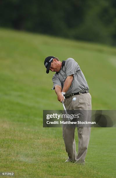 John Cook hits out of the rough on the third fairway during the third round of the Advil Western Open July 6, 2002 at Cog Hill Golf and Country Club...