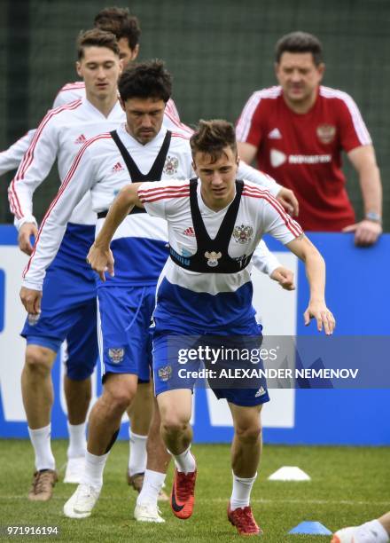 Russia's midfielder Yuri Zhirkov and Russia's midfielder Alexander Golovin attend a training session in Novogorsk outside Moscow on June 12 ahead of...