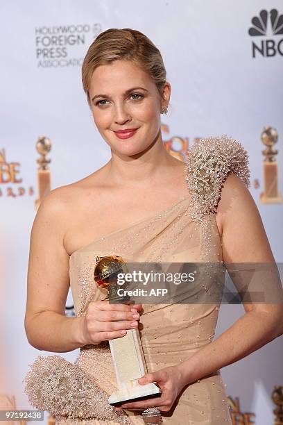 Actress Drew Barrymore poses with her Best Performance by an Actress in a Mini-Series or a Motion Picture Made for Television award for 'Grey...