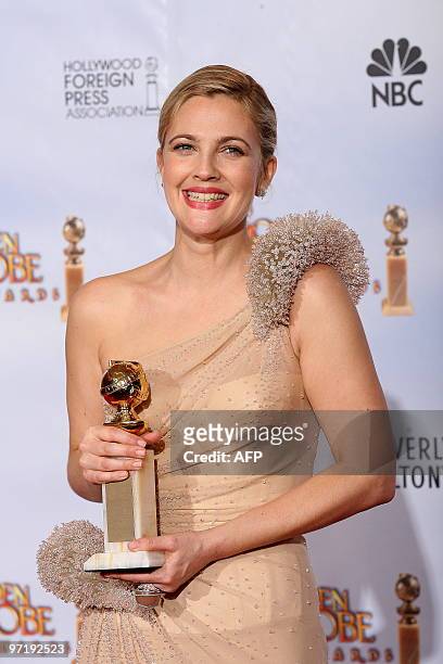 Actress Drew Barrymore poses with her Best Performance by an Actress in a Mini-Series or a Motion Picture Made for Television award for 'Grey...