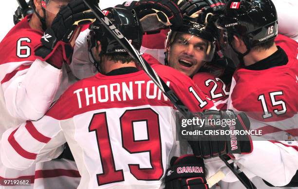 The Canadian team celebrates a goal during the Men's Ice Hockey Quarter-finals game between Russia and Canada at the Canada Hockey Place during the...