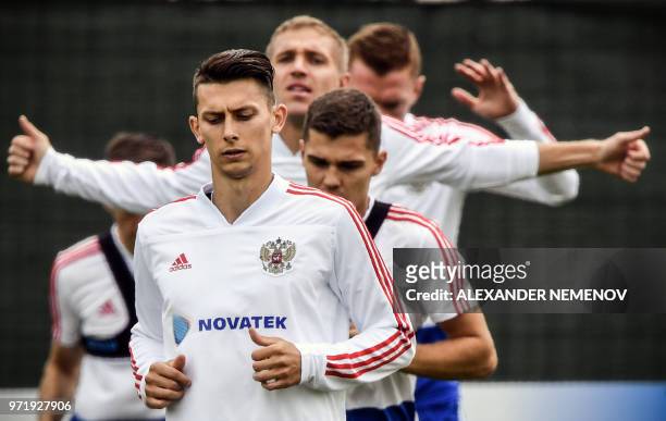 Russia's defender Ilya Kutepov, Russia's midfielder Yuri Gazinskiy, Russia's midfielder Roman Zobnin and Russia's defender Andrey Semyonov attend a...