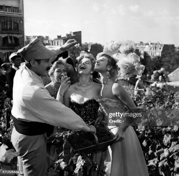 Picture taken on September 29, 1955 showing Parisian cabaret dancers taking part to the traditional grape harvest on Montmarte hill at Paris.