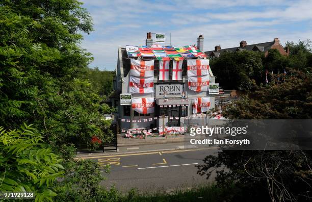 Over 300 flags adorn the Robin pub as it is decorated ahead of the World Cup on June 12, 2018 in Jarrow, England. Managers Clare McFall and Norman...
