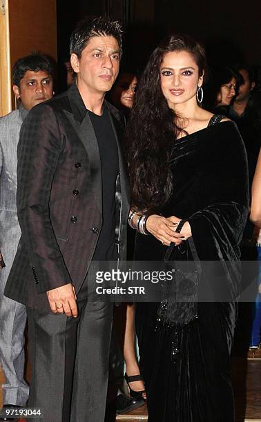 Indian Bollywood actor Shah Rukh Khan and actress Rekha arrive at a soiree held by Head of Reliance Group of Industry Head Anil Dhirubhai Ambani and...