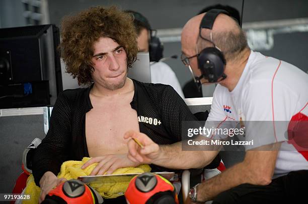 Marco Simoncelli of Italy and San Carlo Honda Gresini speaks wth his chief mechanic in box during the day of testing at Sepang Circuit on February...