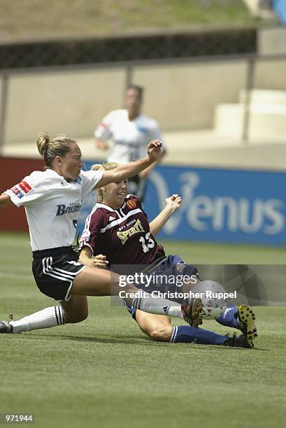 Margaret Tietjen of the San Diego Spirit cuts the corner as Jena Kluegel of the Boston Breakers slides in for a tackle during the second half of...