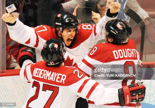 Canadian forward Sidney Crosby celebrates with teammates Scott Niedermayer and Drew Doughty as Canada's team win gold during the Men's Gold Medal...