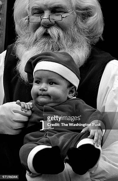 Pentagon City Mall, Arlington, Virginia--PHOTOGRAPHER-MARVIN JOSEPH/TWP--CAPTION- Children visit Santa Claus, to tell him what they want for...