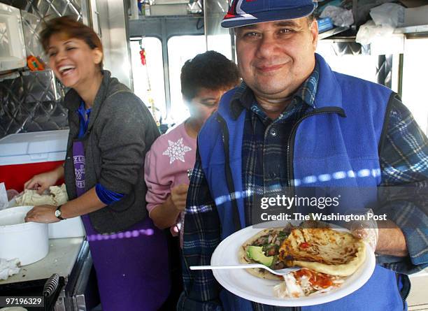 Pupusa vendors in Prince Georges County. Pictured, Juan Rivas, right, works his truck with his niece Esther Rivas, left, and his sister Rube Rivas,...