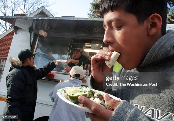 Pupusa vendors in Prince Georges County. Pictured, Max Perea right, digs into his taco from a truck across town, in Riverdale. This area is more...