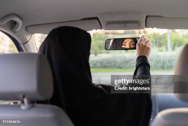 muslim woman driving a car - arab woman driving stock pictures, royalty-free photos & images