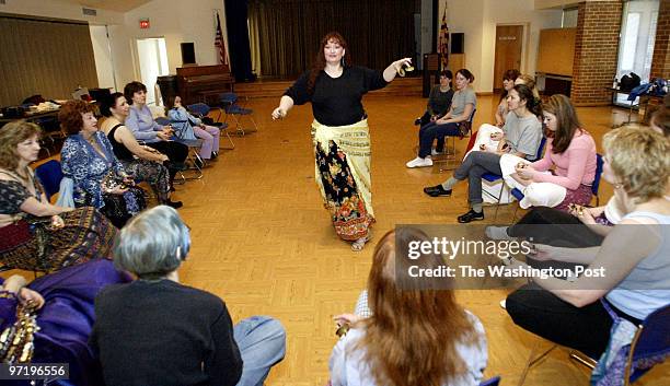 Sm-dance 01-25-03 Mark Gail/TWP Karen Marshall known as Karima demonstrates a graceful move in the art of belly dancing, as she gave lessons at the...