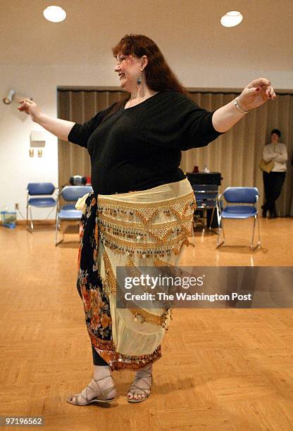 Sm-dance 01-25-03 Mark Gail/TWP Karen Marshall known as Karima demonstrates a graceful move in the art of belly dancing, as she gave lessons at the...