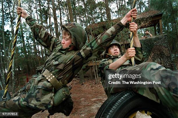 Me/marines Jahi Chikwendiu/TWP Alexandra Murphy, left of Colorado Springs, CO, helps Candice Fleming, of Fredericksburg, VA, cross Laville's Duty...