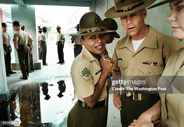 Me/marines Jahi Chikwendiu/TWP Sgt. Faleesha Pilats, center, and SSgt. S. P. Rixmann, hang out during a break in Family Day ceremony rehearsal at...