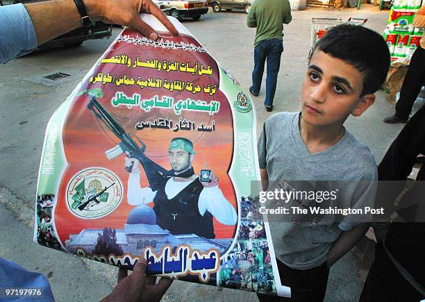 Tulkarem, West Bank 4/11/02 Posters of "martyrs" line walls and stores throughout the West Bank and Gaza. This poster is of Abdel-Bassatt Odeh who...