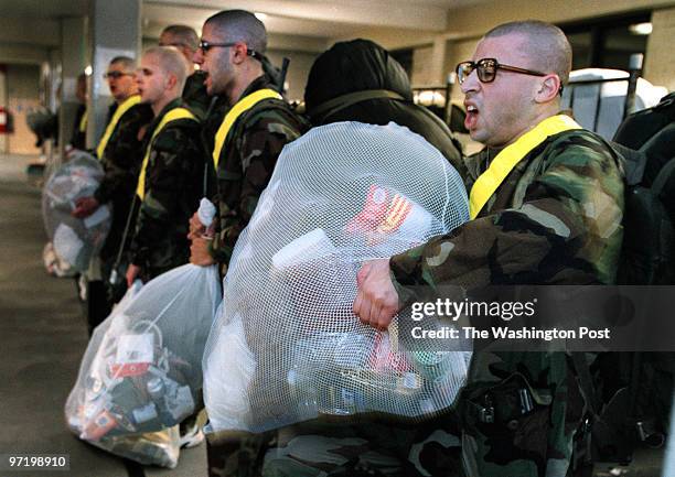 Marines Jahi Chikwendiu/TWP Raif Zakhem struggles to maintain a hold on his personal belongings as the recruits are kept awake for the first nearly...